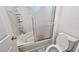 Bathroom featuring a bathtub and shower combination with a sliding glass door and toilet at 3634 Surfboard Ct, Las Vegas, NV 89147