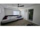 Bedroom with a ceiling fan, carpet, and a view into an en suite bathroom at 3634 Surfboard Ct, Las Vegas, NV 89147