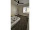 Bedroom featuring a ceiling fan, carpet, and a large window at 3634 Surfboard Ct, Las Vegas, NV 89147