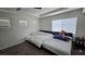 Bright bedroom with multiple beds, plush carpeting, and modern ceiling fan at 3634 Surfboard Ct, Las Vegas, NV 89147