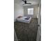 Bedroom with a ceiling fan, carpet, and a view of the street through a window at 3634 Surfboard Ct, Las Vegas, NV 89147