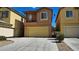 A two-story home featuring a two car garage, front porch, neutral toned stucco, and desert landscaping at 3634 Surfboard Ct, Las Vegas, NV 89147