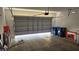 Spacious garage with an open door provides ample storage and parking with room for projects at 3634 Surfboard Ct, Las Vegas, NV 89147