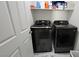 Laundry room features a full-size, front-load washer and dryer on a tiled floor at 3634 Surfboard Ct, Las Vegas, NV 89147