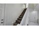 Carpeted staircase with white railing leads to the upper level, enhancing the home's interior design at 3634 Surfboard Ct, Las Vegas, NV 89147