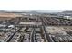 This aerial view shows a planned community, adjacent roads, and barren land with a mountain backdrop at 4211 Enchanting Sky Ave, North Las Vegas, NV 89081