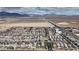 A beautiful aerial view showcases the community, desert landscape, and mountain views in the distance at 4211 Enchanting Sky Ave, North Las Vegas, NV 89081
