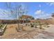 Backyard featuring a wooden pergola, desert landscaping, and rock groundcover at 4211 Enchanting Sky Ave, North Las Vegas, NV 89081