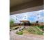Inviting backyard featuring a pergola, lush landscaping, and brick-paved pathway at 4211 Enchanting Sky Ave, North Las Vegas, NV 89081