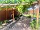 Backyard space featuring a lush grape vine covered wooden pergola, and shade at 4211 Enchanting Sky Ave, North Las Vegas, NV 89081
