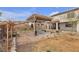 Backyard featuring a wooden pergola with seating and desert landscaping at 4211 Enchanting Sky Ave, North Las Vegas, NV 89081