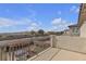 Balcony with wrought iron railing and views of the neighborhood and distant hills at 4211 Enchanting Sky Ave, North Las Vegas, NV 89081