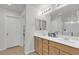 This bathroom features a vanity with dual sinks, walk-in shower and toilet at 4211 Enchanting Sky Ave, North Las Vegas, NV 89081