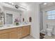 Bright bathroom with double sinks, wood cabinets, a large mirror, and a separate shower at 4211 Enchanting Sky Ave, North Las Vegas, NV 89081