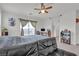 This bedroom features carpeted floors, ceiling fan, balcony access and closet at 4211 Enchanting Sky Ave, North Las Vegas, NV 89081
