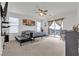 Bedroom features a ceiling fan, carpet flooring, sofa and balcony access at 4211 Enchanting Sky Ave, North Las Vegas, NV 89081
