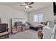 This bedroom features carpeted floors, a ceiling fan and window at 4211 Enchanting Sky Ave, North Las Vegas, NV 89081