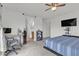 This bedroom features carpeted floors, ceiling fan, computer desk and closet at 4211 Enchanting Sky Ave, North Las Vegas, NV 89081