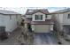 Two-story home with a tile roof, stone accents, and a paved driveway leading to a two-car garage at 4211 Enchanting Sky Ave, North Las Vegas, NV 89081