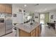 Spacious kitchen featuring granite counters, wood cabinets and a center island open to the living area at 4211 Enchanting Sky Ave, North Las Vegas, NV 89081
