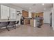 Kitchen with granite counters, stainless appliances, mosaic backsplash and light wood cabinets with a dining area nearby at 4211 Enchanting Sky Ave, North Las Vegas, NV 89081