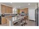 Open kitchen with a center island, granite counters, stainless steel appliances, and a tile backsplash at 4211 Enchanting Sky Ave, North Las Vegas, NV 89081