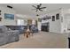 Spacious living room features a ceiling fan, neutral carpet, and a comfortable gray sectional sofa at 4211 Enchanting Sky Ave, North Las Vegas, NV 89081