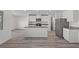 Open concept kitchen with a central island, stainless steel appliances, and hardwood floors at 4244 Golden Sol St, North Las Vegas, NV 89032
