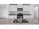 Modern kitchen island with a stainless steel sink and faucet, complemented by white cabinetry at 4244 Golden Sol St, North Las Vegas, NV 89032