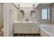 Light and bright bathroom boasts dual sinks and large soaking tub at 4704 Obannon Dr # B, Las Vegas, NV 89102