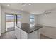 Open-concept kitchen with a view to the yard and living room with lots of natural light at 4940 Canna Lily St, Las Vegas, NV 89122
