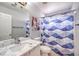 Bathroom featuring a marble countertop, a shower with blue patterned curtains at 5032 Dancing Lights Ave, Las Vegas, NV 89130