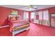 Bright bedroom with red carpet, ceiling fan, and a large mirror at 5032 Dancing Lights Ave, Las Vegas, NV 89130