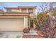 Two-story home with a two-car garage, desert landscaping, and a brown front door at 5032 Dancing Lights Ave, Las Vegas, NV 89130