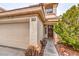 Close-up of the home's front entrance and garage, showcasing desert landscaping at 5032 Dancing Lights Ave, Las Vegas, NV 89130