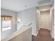 Upstairs hallway featuring a window with blinds, a decorative wall sconce, and neutral paint at 5032 Dancing Lights Ave, Las Vegas, NV 89130