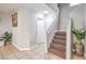 Hallway featuring neutral tile flooring, a staircase with patterned carpet, and doorways to other rooms at 5032 Dancing Lights Ave, Las Vegas, NV 89130