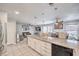 Open kitchen with granite island overlooking the living and dining areas; modern ceiling fan and stainless appliances at 5032 Dancing Lights Ave, Las Vegas, NV 89130
