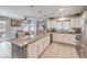 Spacious kitchen with granite counters, white cabinets, stainless appliances and view to the dining area at 5032 Dancing Lights Ave, Las Vegas, NV 89130