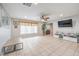 Light-filled living room with large window, tiled floors, recessed lights, and an entertainment center for storage at 5032 Dancing Lights Ave, Las Vegas, NV 89130