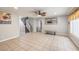 Bright living area with tiled floors, recessed lights, view of the staircase and a baby safety gate at the opening at 5032 Dancing Lights Ave, Las Vegas, NV 89130