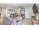 Comfortable living room with neutral decor, tiled flooring, ceiling fan, and a cozy seating arrangement at 5032 Dancing Lights Ave, Las Vegas, NV 89130