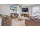 Spacious living room featuring a large television, tiled flooring, ceiling fan, and neutral-toned decor at 5032 Dancing Lights Ave, Las Vegas, NV 89130