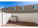 Backyard featuring stone pavers, gravel, a white fence, and a storage unit at 5615 Distelrath Ave, Las Vegas, NV 89122