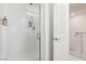 Bathroom showcasing a glass shower with silver hardware and ceramic tile, next to a white door at 5615 Distelrath Ave, Las Vegas, NV 89122