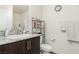 Bathroom featuring granite countertops, a sink with a chrome faucet, dark wood cabinets, and a toilet at 5615 Distelrath Ave, Las Vegas, NV 89122