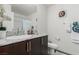 Bathroom featuring a modern vanity with a granite countertop, a sink, and a toilet with white towels at 5615 Distelrath Ave, Las Vegas, NV 89122