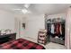 Bright bedroom featuring a ceiling fan, black dresser, plush decor, and organized closet with additional shelving at 5615 Distelrath Ave, Las Vegas, NV 89122