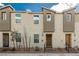 Charming townhome featuring a modern facade with stone accents and a welcoming front door at 5615 Distelrath Ave, Las Vegas, NV 89122