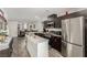 Stylish kitchen featuring stainless steel appliances and a center island open to the living area at 5615 Distelrath Ave, Las Vegas, NV 89122